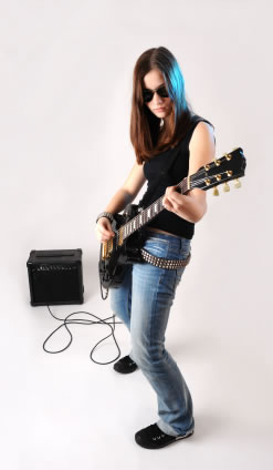 Rocker girl with her guitar and amp